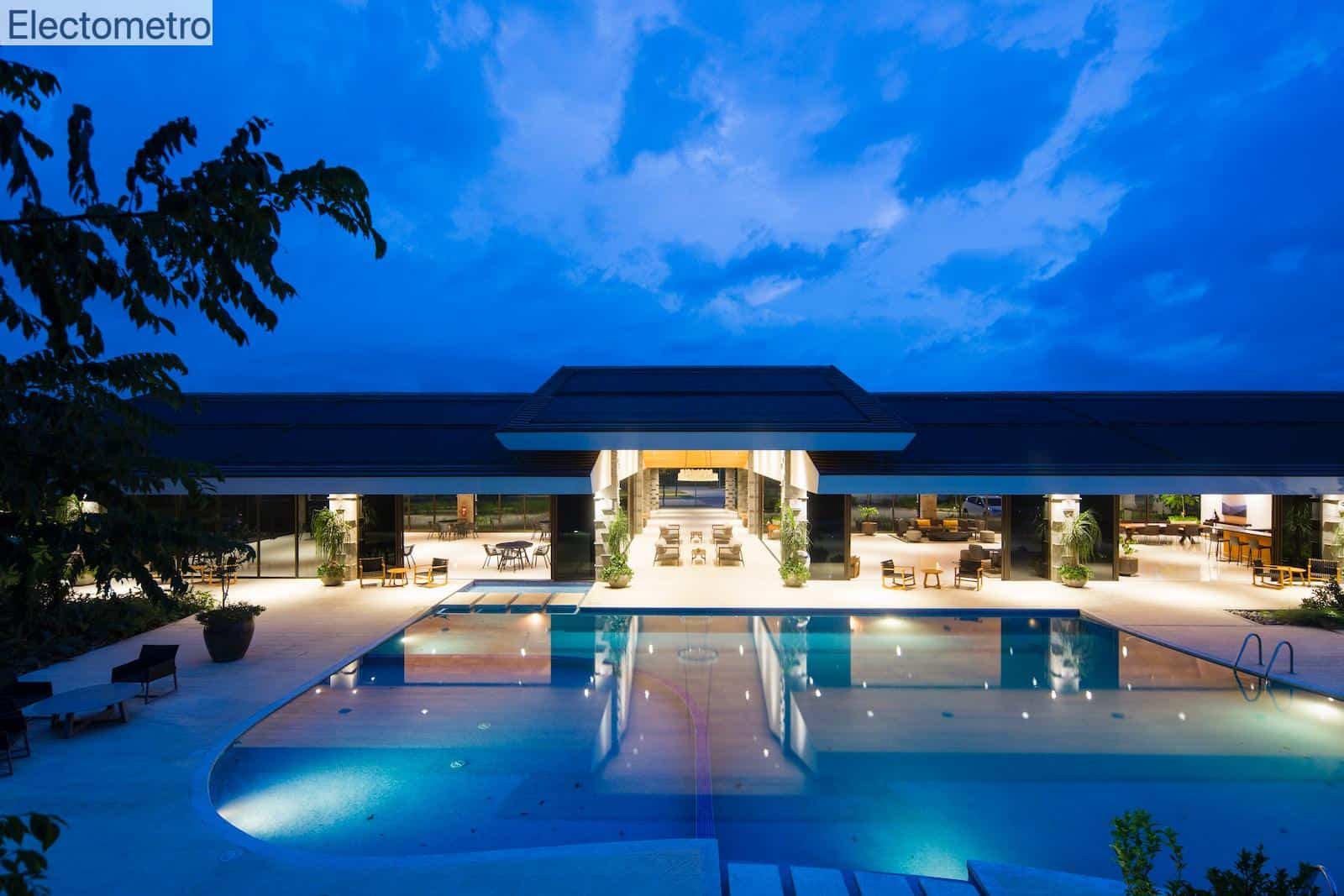 blue body of water in front of building near trees during nighttime