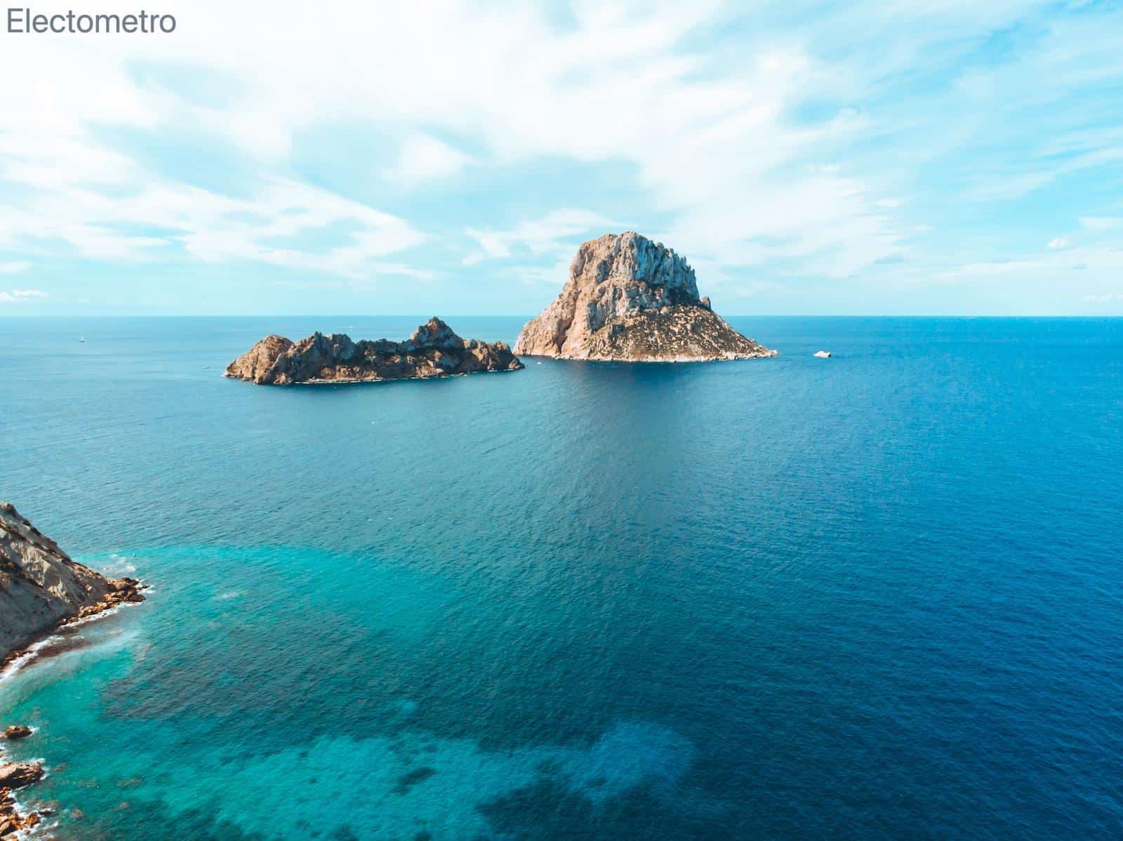 gray and brown rock formation on blue sea under blue sky during daytime