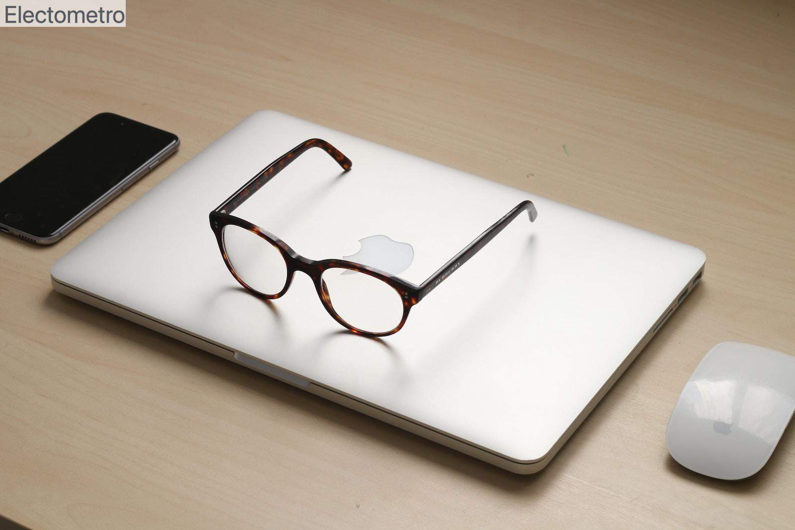 tortoiseshell framed sunglasses on silver MacBook