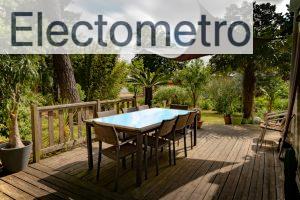 brown wooden table with chairs and umbrella