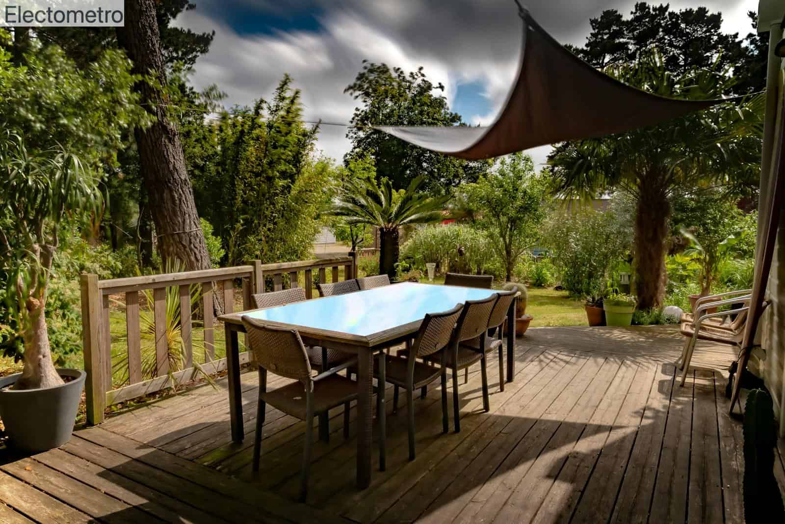 brown wooden table with chairs and umbrella