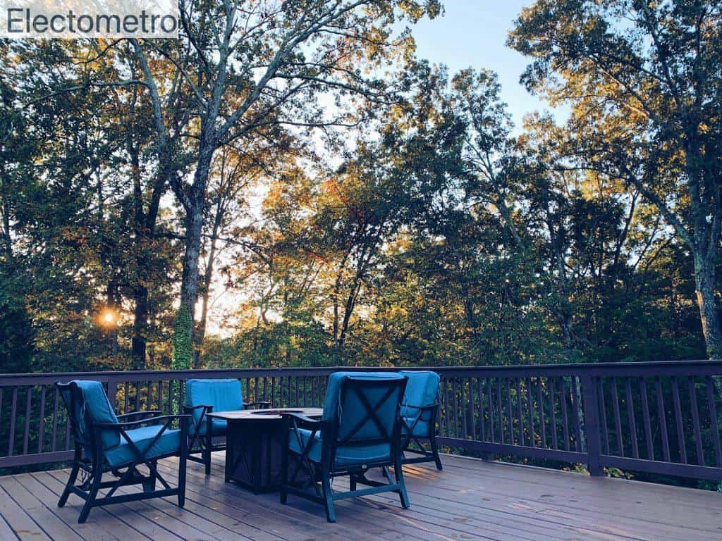 black metal chairs and table near green trees during daytime